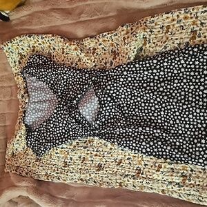 Black dress with yellow and white flowers on it